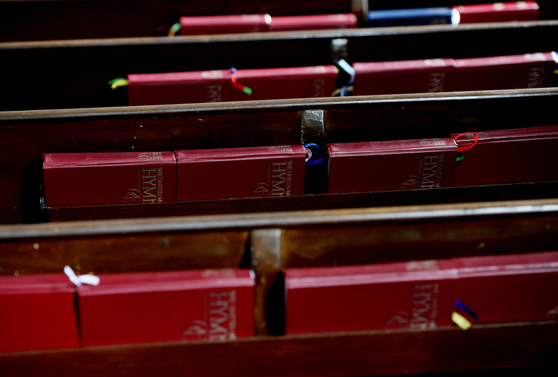 Hymnals line the backs of pews at First United Methodist Church.