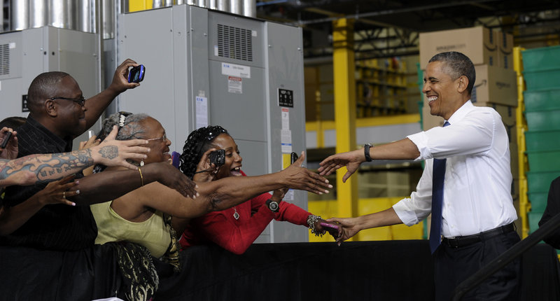 President Obama shakes hands as he arrives to speak at the Amazon fulfillment center in Chattanooga, Tenn., Tuesday as he offered up a new jobs package.