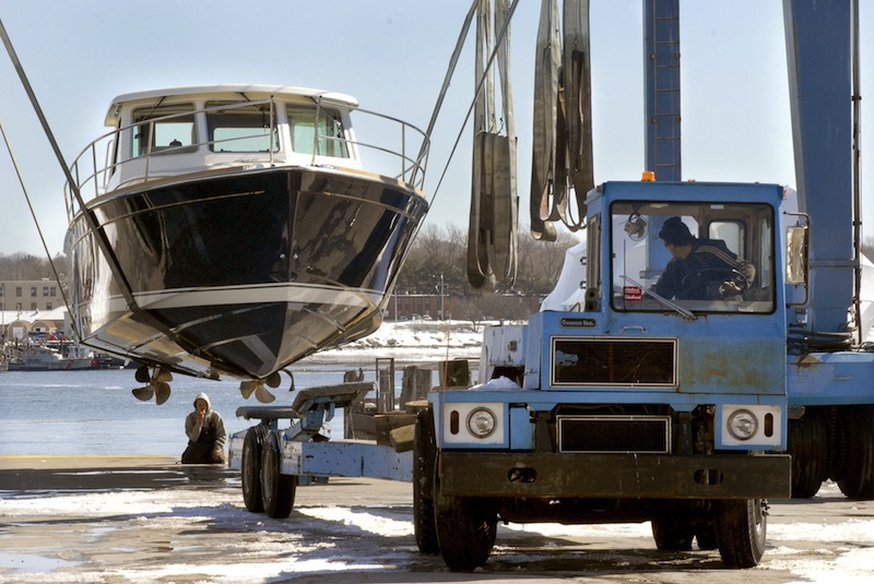 In this March 2009 file photo, workers guide a trailer under a 38-foot Sabre "Express" from a travel lift at Gowen Marine in Portland. Gowen Marine has been sold to Phineas Sprague, the latest development in a serious of moving parts on the city's waterfront.