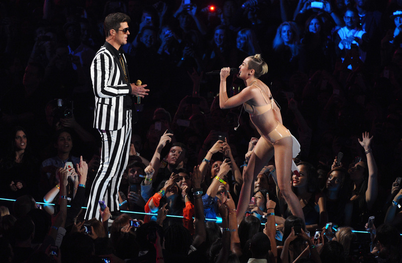 Robin Thicke and Miley Cyrus, wearing a flesh-colored bikini, perform "Blurred Lines" at the MTV Video Music Awards on Sunday in New York.