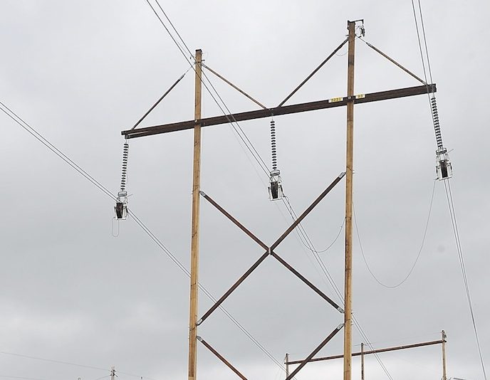 In this May 2013 file photo, power lines at the corner of County Road and Smutty Lane in Saco. A federal judge has ruled that New England electric transmission companies should make less money on power line projects, a decision Massachusetts' attorney general said could lower electric bills.