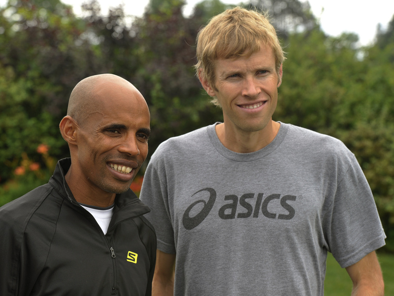 Elite runners Meb Keflezighi and Ryan Hall pose for photos following a Beach to Beacon news conference Friday.