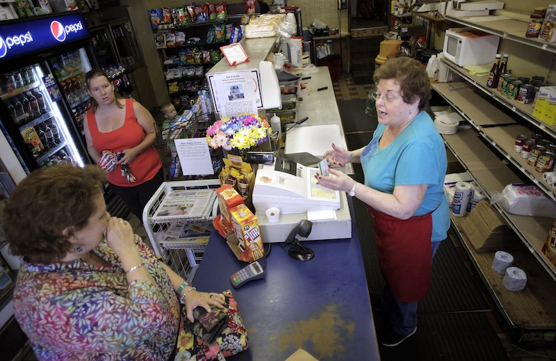 Eleanor DiPietro, at right, owner of DiPietro's Italian Sandwiches, chats with customer Ellen Deering, bottom left, during the dinner rush Thursday, August 8, 2013. The store will be closing its doors next Sunday, August 18, after generations in business.