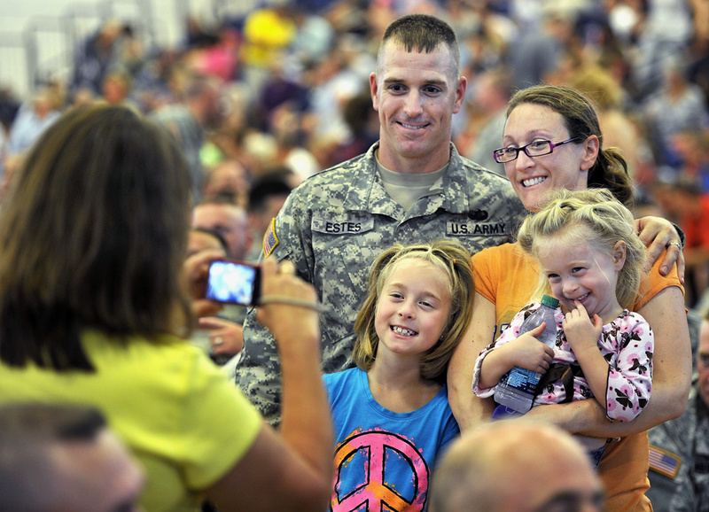 Staff Sgt. Ryan Estes and his family pose for a photo before the start of Saturday's "Hero's Send-Off Ceremony" at the Portland Expo. He is a member of a Maine Army National Guard unit that is deploying to Afghanistan. With him are his wife, Myra; and daughters Peyton, 8, left, and Dakota, 3.