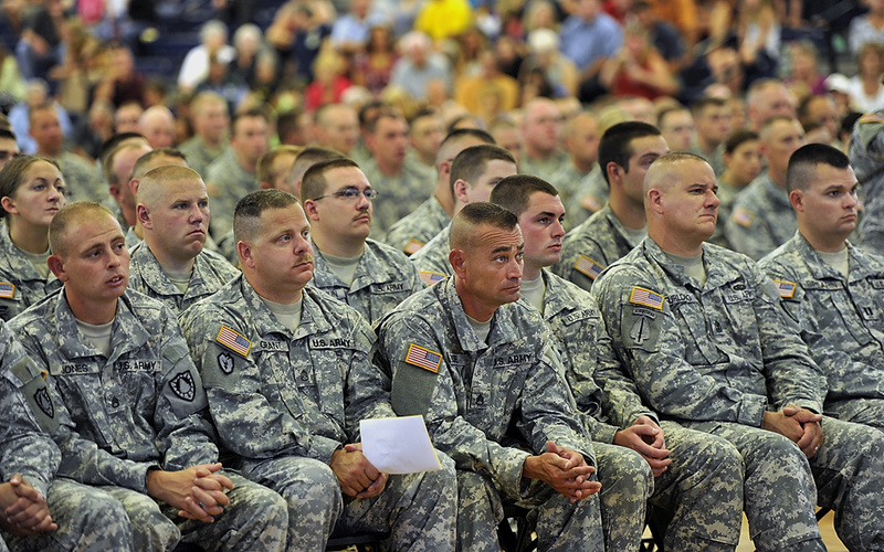 Guardsmen listen intently as speakers thank them for their service during the "Hero's Send Off Ceremony" at the Portland Expo Saturday.