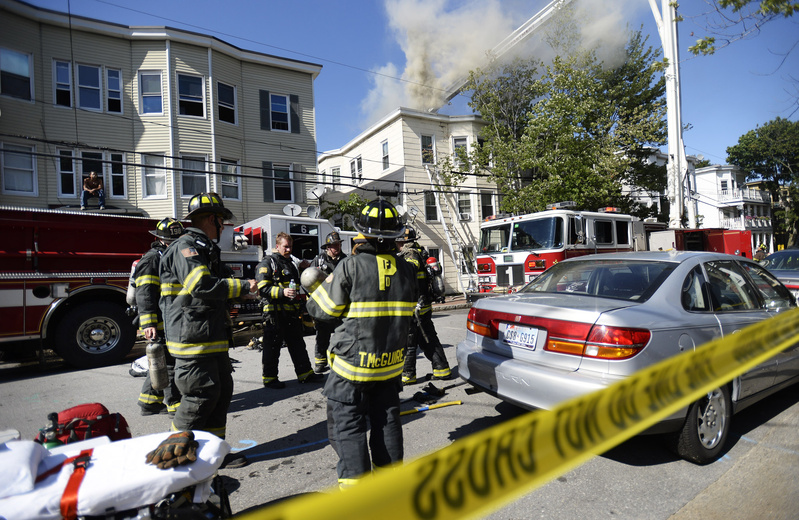 A two-alarm fire heavily damaged the top story of a three-story apartment building on Grant Street in Portland on Wednesday.