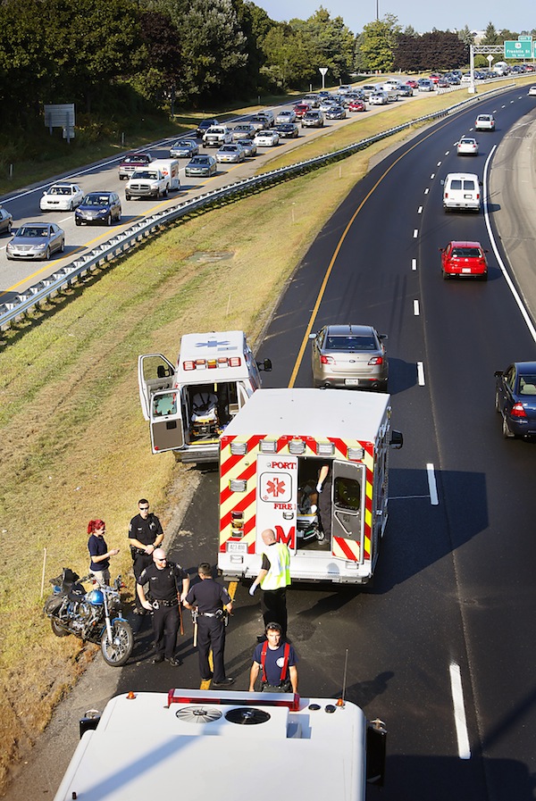 Rescue personnel respond to a motorcycle crash on the northbound lane of Interstate 295 near the Deering Avenue overpass in Portland on August 27, 2013.