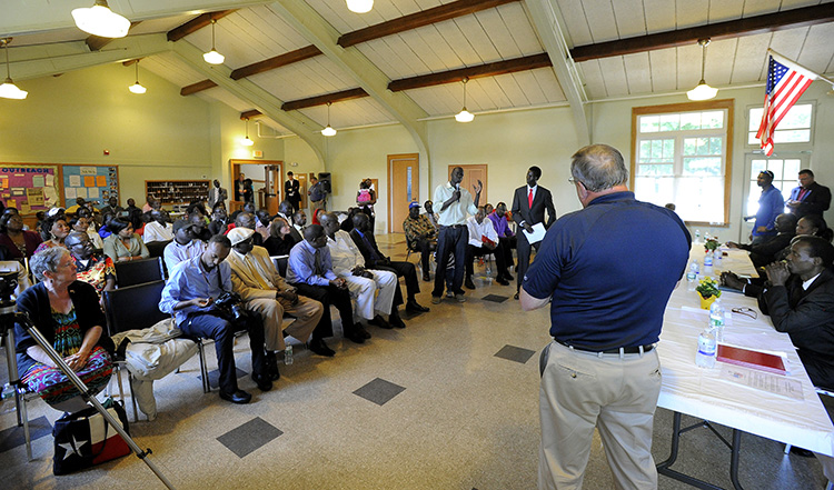 Gov. Paul LePage takes a question from Alfred Jacob as he visits members of the Sudanese community at Trinity Episcopal Church in Portland on Friday.