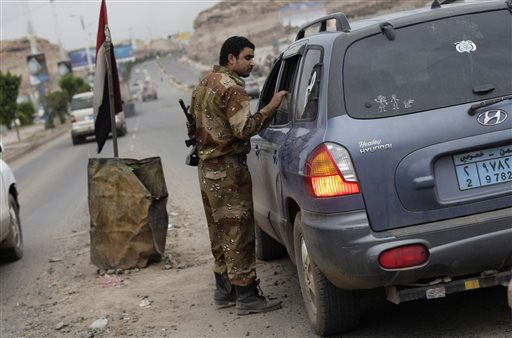 A Yemeni soldier inspects a car at a checkpoint on a street leading to the U.S. embassy in Sanaa, Yemen, on Sunday. Security forces closed access roads, put up extra blast walls and beefed up patrols near U.S. diplomatic missions that Washington ordered closed for the weekend over a ``significant threat'' of an al-Qaida attack.