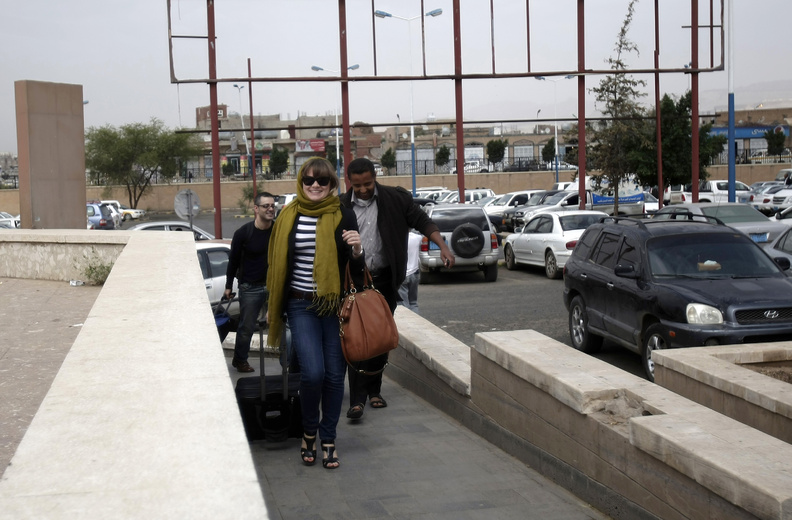 Travelers make their way to the departure lounge at Sanaa International Airport in Yemen on Tuesday. The State Department ordered non-essential personnel at the U.S. Embassy in Yemen to leave the country.