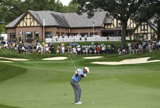 Tiger Woods hits to the 18th green during a practice round Tuesday for the PGA Championship golf tournament at Oak Hill Country Club in Pittsford, N.Y.