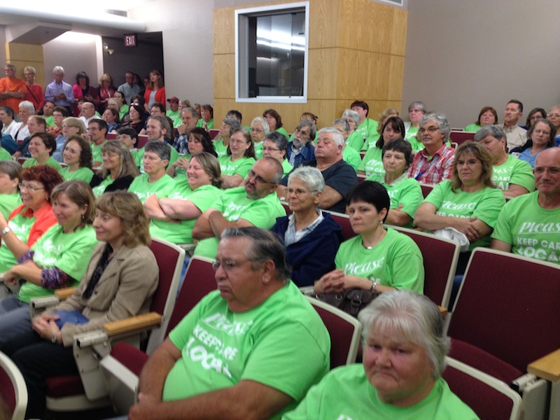 Hundreds of people attended a public hearing in Auburn on Thursday, Aug. 29, 2013 to testify against a proposed partnership between insurer Anthem Blue Cross and Blue Shield and MaineHealth. Scores of people waiting to speak wore neon green t-shirts with the slogan "Keep care local."