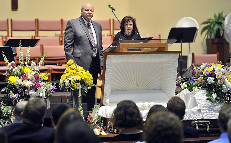 Ashley Drew's mother, Joy Drew, thanks all who helped Ashley through her life as Ashley's father, Tom Drew, waits to share his memories of Ashley at A Celebration of Life for Ashley Drew on Friday.