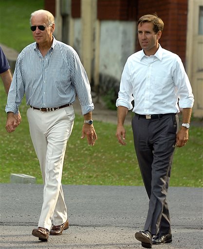In this July 4, 2012 photo, Delaware Attorney General Beau Biden takes a walk with his father, Vice President Joe Biden, to the Green Ridge Little Baseball Field in Scranton, Pa.