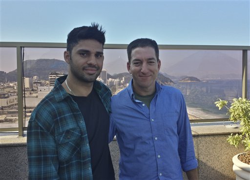 In this undated photo released by Janine Gibson of The Guardian, Guardian journalist Glenn Greenwald, right, and his partner David Miranda, are shown together at an unknown location. Miranda, the partner of Greenwald, a journalist who received leaks from former National Security Agency contractor Edward Snowden, was detained for nearly nine hours Sunday under anti-terror legislation at Heathrow Airport, triggering claims that authorities are trying to interfere with reporting on the issue.