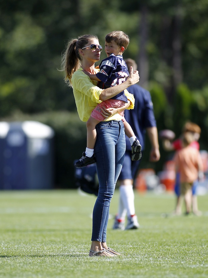 Gisele Bundchen comforts her son Benjamin after he was hurt playing football, following a joint workout with the Tampa Bay Buccaneers and the New England Patriots at NFL football training camp, in Foxborough, Mass., Thursday.
