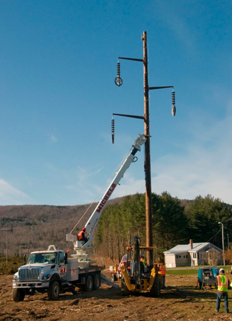 Central Maine Power Co. contractors erect a new 39-mile transmission line from Moscow to Benton in this November 26, 2011 file photo.