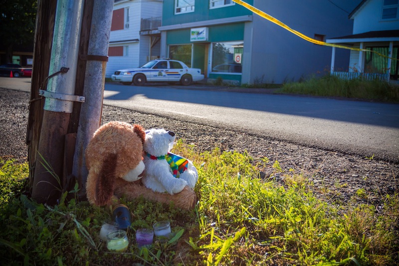 A memorial sits outside the Reptile Ocean exotic pet store in Campbellton, New Brunswick, Canada, on Tuesday, Aug. 6, 2013. Autopsies will be performed Tuesday on two young boys who were strangled in their sleep by a large African rock python that escaped from the pet store and slithered into the living room of an apartment upstairs from the pet store. (AP Photo/The Canadian Press, John LeBlanc)