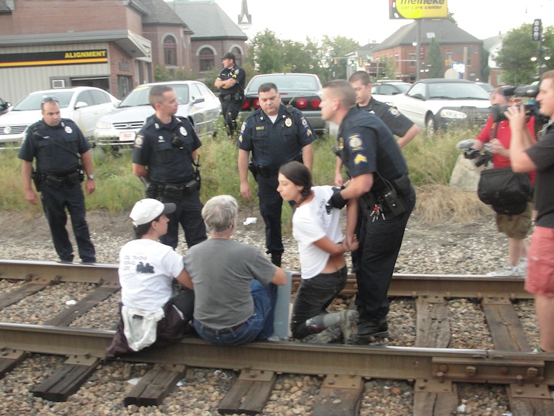 Three people were arrested Wednesday, Aug. 28, 2013 after staging an oil-train protest on railroad tracks in downtown Auburn, Maine.