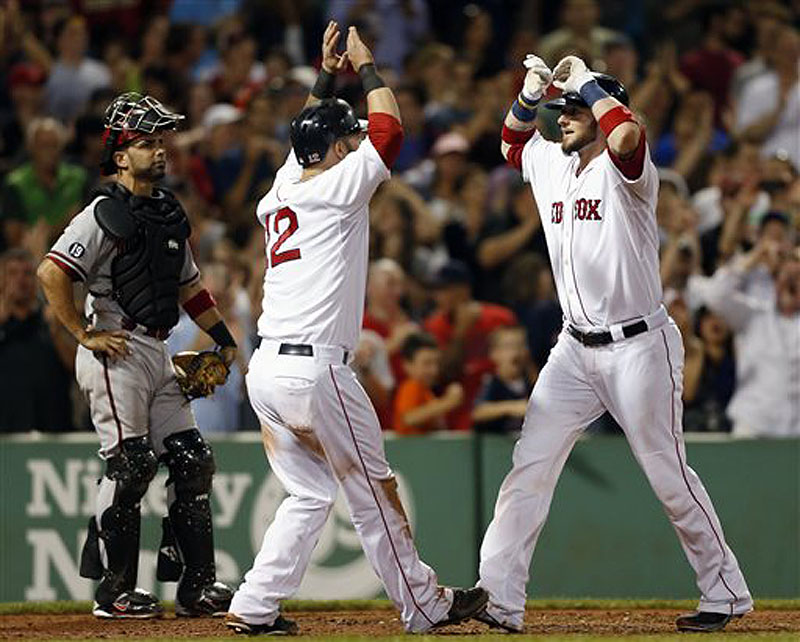 Jarrod Saltalamacchia, right, celebrates his two-run home run that also drove in Mike Napoli (12) as Diamondbacks catcher Wil Nieves, left, looks on in the eighth inning at Fenway Park on Saturday.