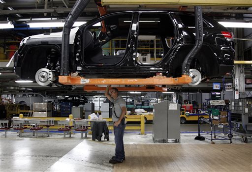 A worker checks the chassis of a vehicle on the assembly line at Chrysler's Jefferson North Assembly plant in Detroit in this May 2013 photo.