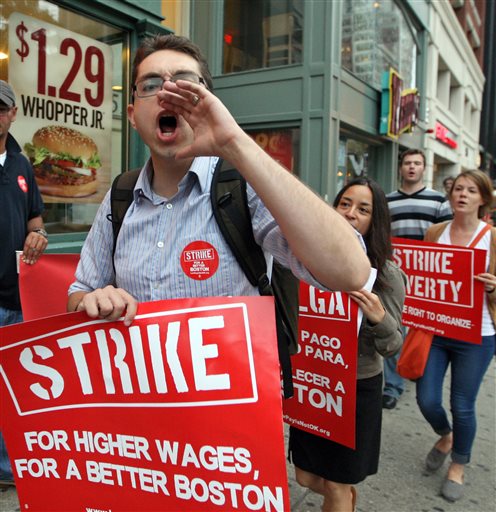 Protesters vocalize their demands for better pay in the fast-food industry Thursday outside a Boston Burger King.