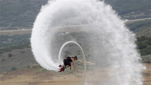 Flyboard instructor Chase Shaw flips with his flyboard, on the Jordanelle Reservoir, at Jordanelle State Park, Utah. The Flyboard, which looks like a small snowboard attached to a hose, can propel you 45 feet in the air using water pumped from a personal watercraft like a Jet Ski to the base of the board.