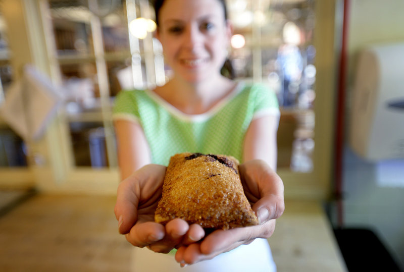 Jessica Barry displays a wild Maine blueberry hand pie, a new and popular menu item currently available only on Fridays, Saturdays and Sundays at Standard Baking Co. in Portland.