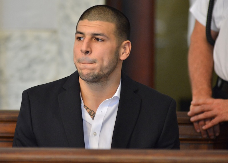 Former New England Patriot football player Aaron Hernandez, listens to procedings in a court in Attleboro, Mass., Thursday, Aug. 22, 2013. Hernandez was indicted on first-degree murder and weapons charges in the death of a friend whose bullet-riddled body was found in an industrial park about a mile from the ex-player's home. (AP Photo/Josh Reynolds)