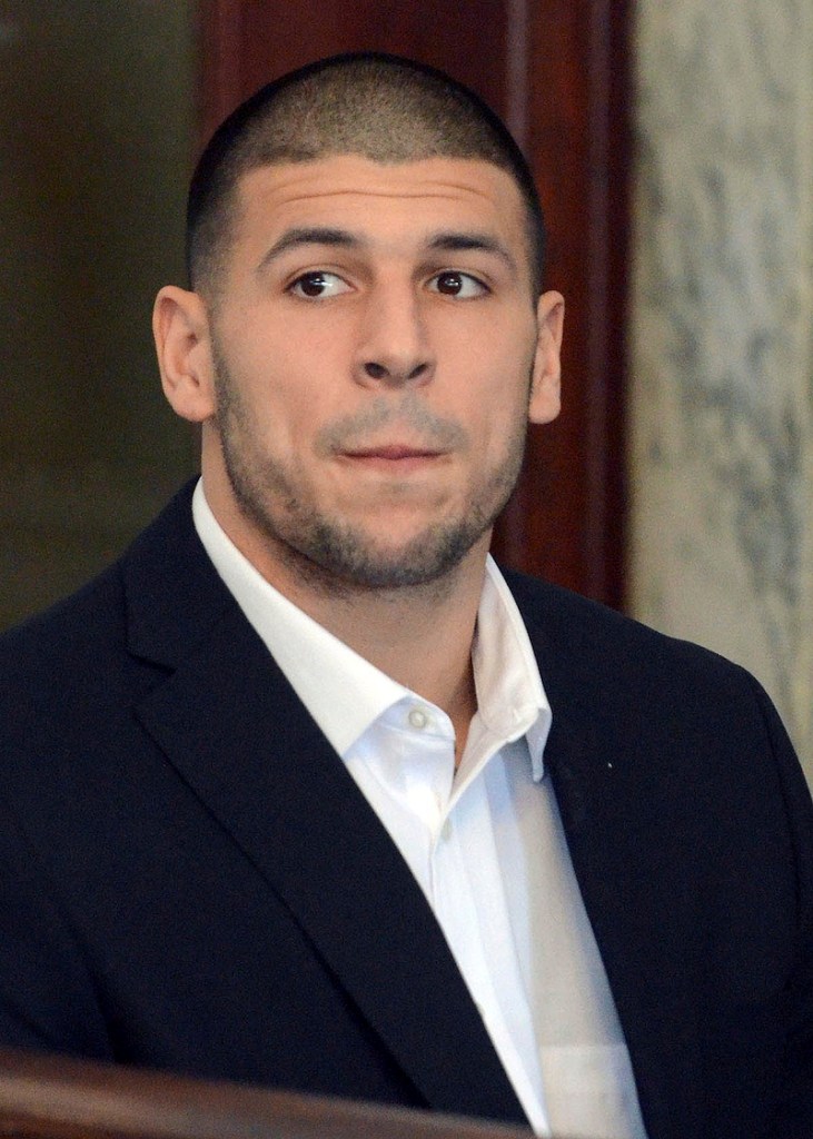 Former New England Patriots football player Aaron Hernandez sits during a brief hearing in district court on Friday, Aug. 30, 2013, in Attleboro, Mass. Hernandez was indicted on a murder charge last week in the killing of Odin Lloyd. He pleaded not guilty to murder in district court in June. (AP photo/ The Sun Chronicle, Mike George, Pool)