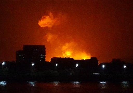 The night sky is lit up as a fire burns aboard INS Sindhurakshak, an Indian Navy kilo class submarine, early Wednesday in Mumbai, India. The submarine caught fire after an explosion aboard the vessel, and sank.