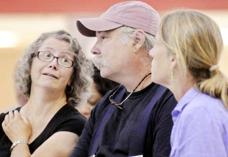 Lisa, left, and Ralph Turner of Laughing Stock Farm in Freeport and Jan Goranson of Goranson Farm in Dresden listen to Food and Drug Administration Deputy Commissioner of Food Safety Michael Taylor speak Monday in Augusta about new rules for farmers to reduce food-borne illness.