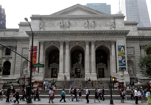 Pedestrians walk past the entrance to the main branch of the New York Public Library.