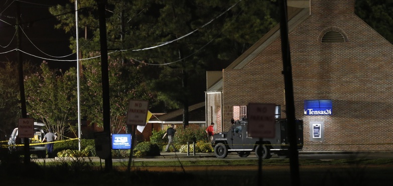 Investigators work during the early-morning hours Wednesday at the Tensas State Bank branch in St. Joseph, La., where a gunman took three people hostage Tuesday.