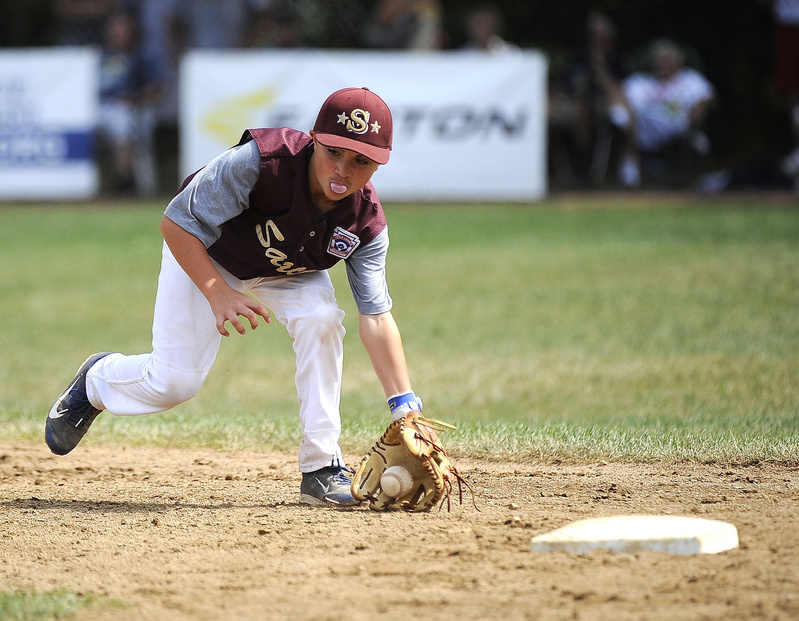 Saco's Luke Chessie blows a bubble while fielding a ground ball during the New England semifinal at the 2013 Eastern Regional Little League Tournament at Breen Field in Bristol, Conn., on Thursday.