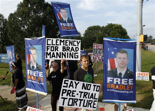 Supporters of Army Pfc. Bradley Manning hold up banners and signs as they protest outside of the gates at Fort Meade, Md., Wednesday, before a sentencing hearing in Manning's court martial.