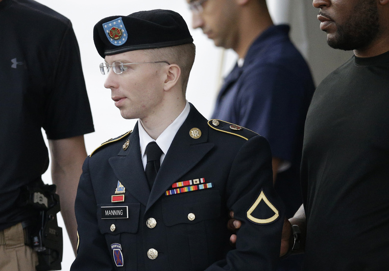 Army Pfc. Bradley Manning is escorted to a waiting security vehicle outside of a courthouse in Fort Meade, Md., last month.