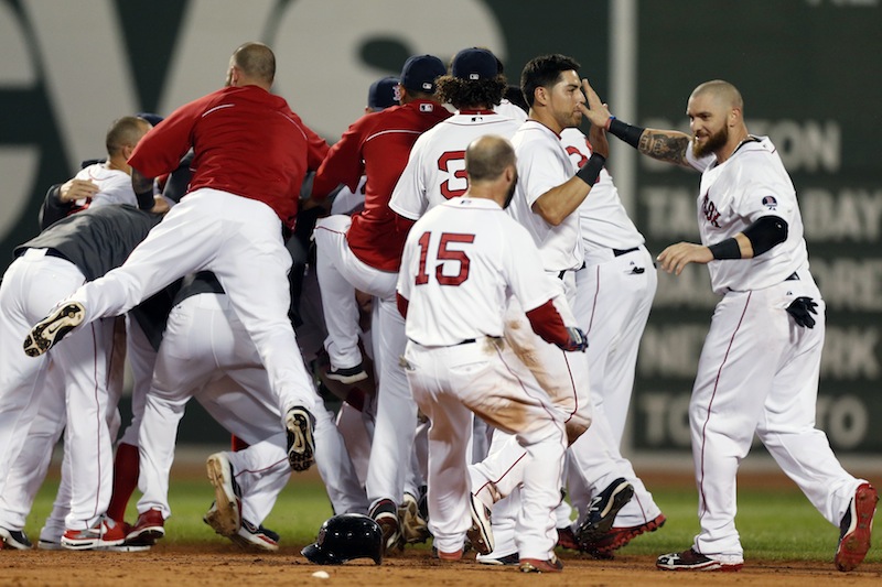 The Boston Red Sox including Jonny Gomes, right, Jacoby Ellsbury, second from right, and Dustin Pedroia (15) celebrate after a walkoff-single by Daniel Nava that scored Pedroia in the ninth inning of a baseball game against the Seattle Mariners in Boston, Thursday, Aug. 1, 2013. The Red Sox won 8-7. (AP Photo/Michael Dwyer)