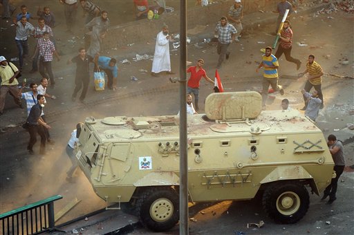 Supporters of ousted Islamist President Mohammed Morsi capture an Egyptian security forces vehicle at the Ministry of Finance in Cairo on Wednesday.