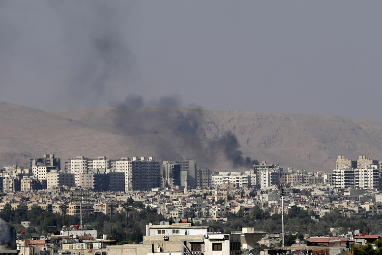 Black columns of smoke rise from heavy shelling in Barzeh, a suburb of Damascus, Syria, on Friday.