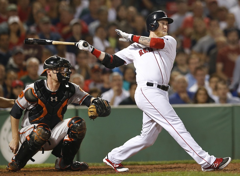 Boston's Mike Carp hits a pinch-hit single to drive in a run as Baltimore Orioles catcher Matt Wieters watches in the eighth inning at Fenway Park in Boston on Wednesday. It proved to be the winning run as the Red Sox won 4-3.