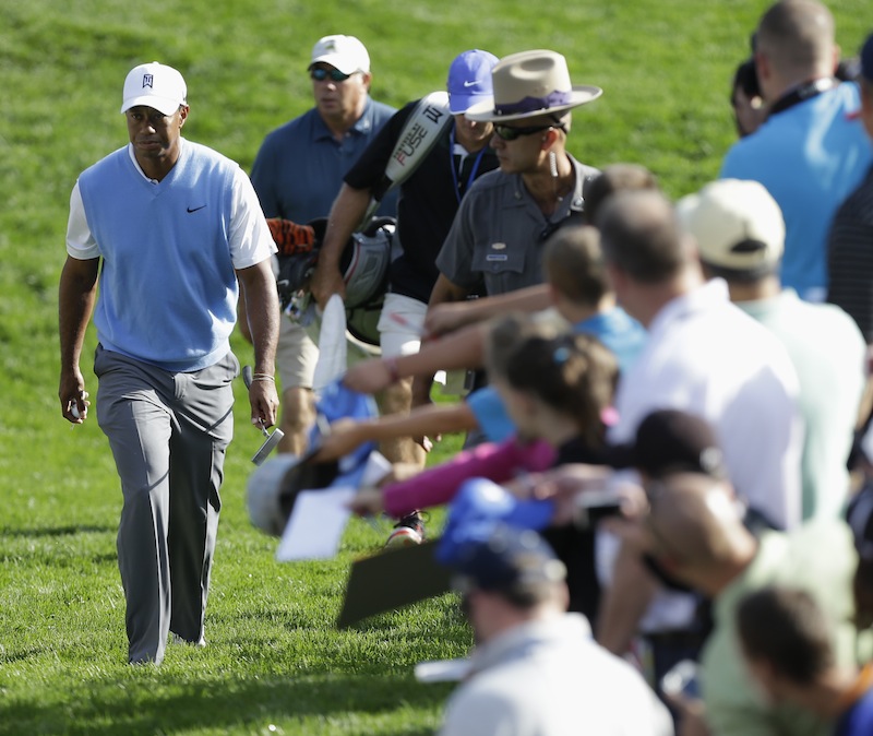 Tiger Woods walks to the 16th tee during a practice round for the PGA Championship golf tournament at Oak Hill Country Club, Tuesday, Aug. 6, 2013, in Pittsford, N.Y. (AP Photo/Charlie Neibergall)