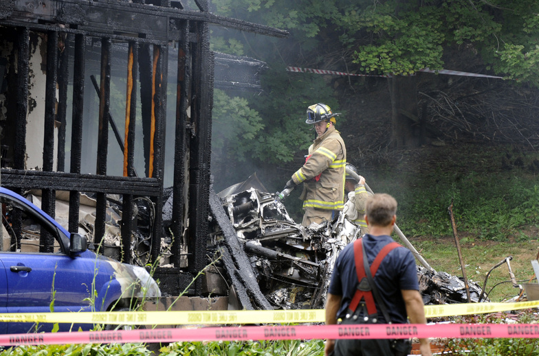 Firefighters work at the scene of a small plane crash Friday in East Haven, Conn.