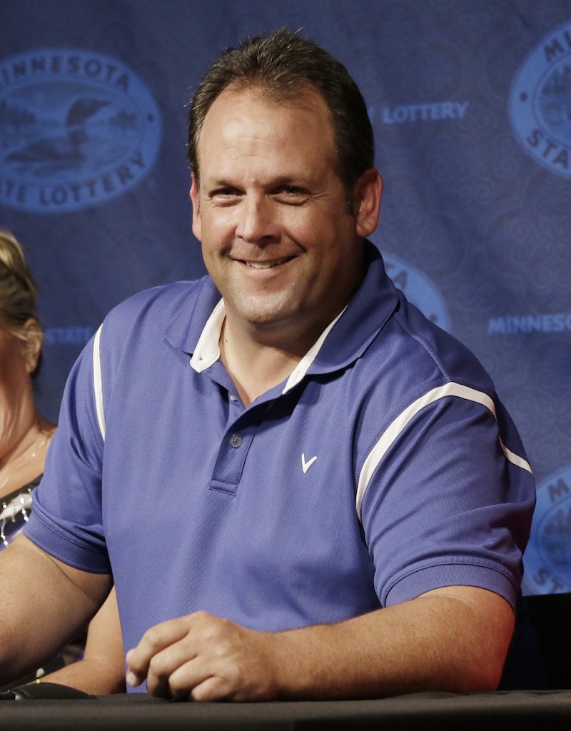 Paul White, of Ham Lake, Minn. has reason to smile after he was announced as one of the winners of the $448.4 million Powerball Jackpot, Thursday, Aug. 8, 2013 in Minneapolis. White's share of the jackpot is $149.4 million. The woman at left is a co-worker friend. (AP Photo/Jim Mone)