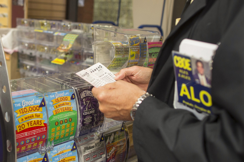 Douglas Priskalo purchases Powerball tickets at a convenience store in Chicago Wednesday.