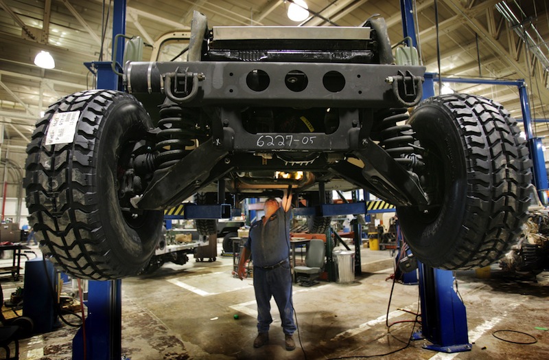 A mechanic inspects the underside of a refurbished Humvee at the Maine Military Authority in Limestone in 2005. Over the years, Maine Military Authority refurbished more than 16,000 vehicles, generated $600 million in revenue and, at its peak, employed roughly 550 workers.