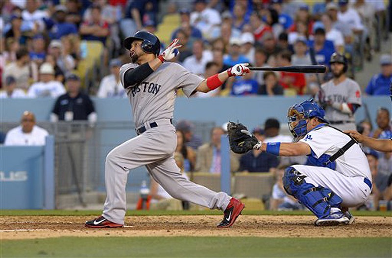 Boston's Shane Victorino hits a solo home run in the seventh inning Sunday in Los Angeles. The Red Sox beat the Dodgers, 8-1.