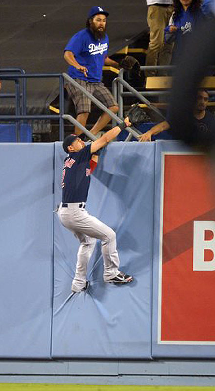 Red Sox center fielder Jacoby Ellsbury climbs the wall as he tries to catch a ball hit for a two-run home run by the Dodgers' Hanley Ramirez in the fourth inning Friday in Los Angeles.