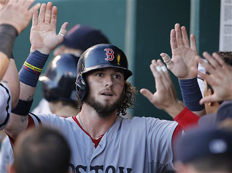 Jarrod Saltalamacchia is welcomed by his teammates in the Boston Red Sox dugout Saturday night after scoring on a Will Middlebrooks single in the fourth inning of a 5-3 victory against the Kansas City Royals.