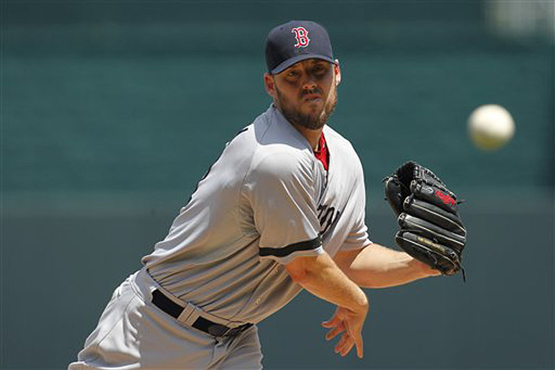 Boston Red Sox pitcher John Lackey warms up in the first inning of Sunday's game against the Kansas City Royals.